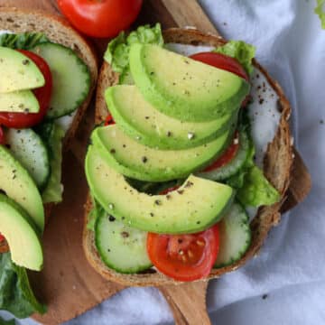 Open face veggie sandwich on a small board