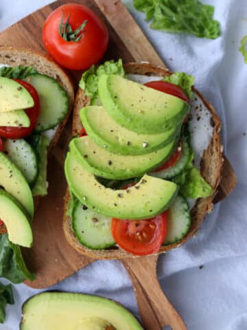 Open face veggie sandwich on a small board