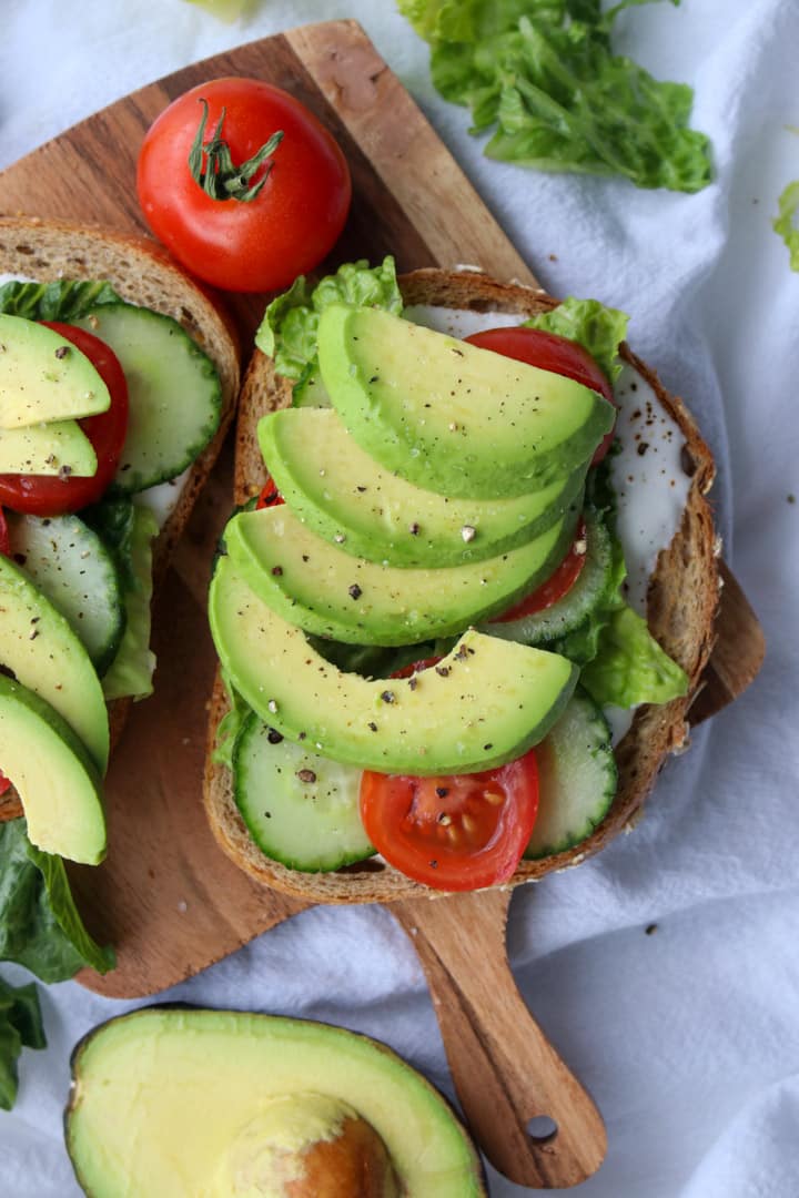 Open face veggie sandwich on a small board