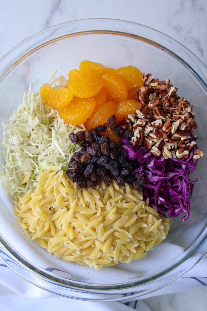 bowl of ingredient to make creamy orzo coleslaw