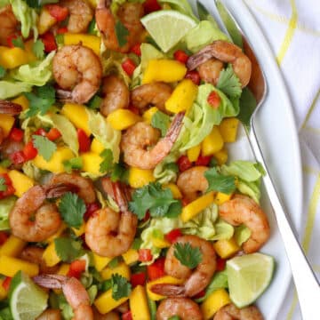 Shrimp and Mango salad on a plate with a large fork