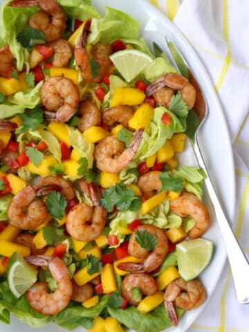 Shrimp and Mango salad on a plate with a large fork