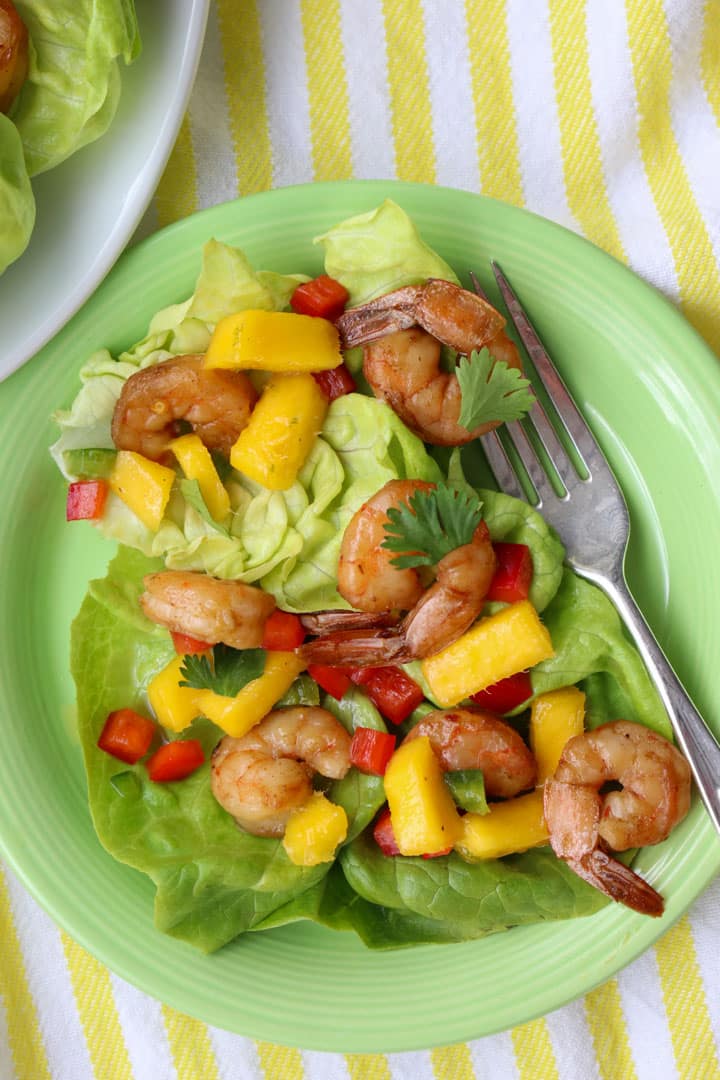 Shrimp and Mango Salad on a green plate with a fork