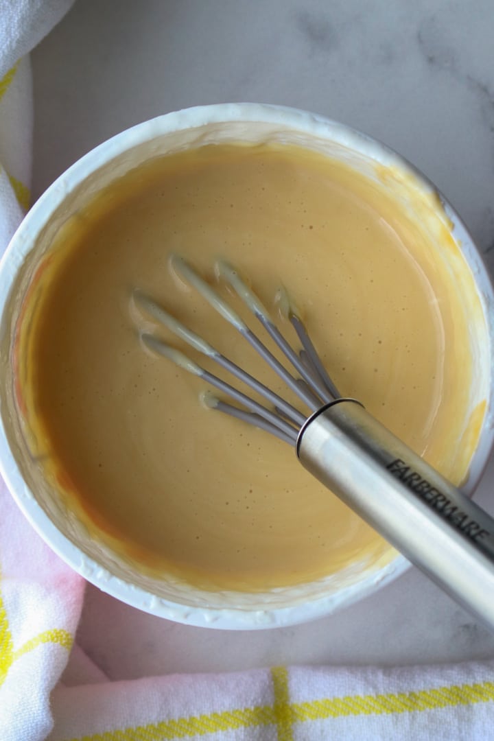 Whipped Cottage Cheese Caramel Dip in a bowl with a whisk