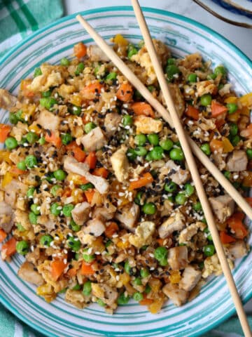 bowl of cauliflower pork fried rice with chop sticks