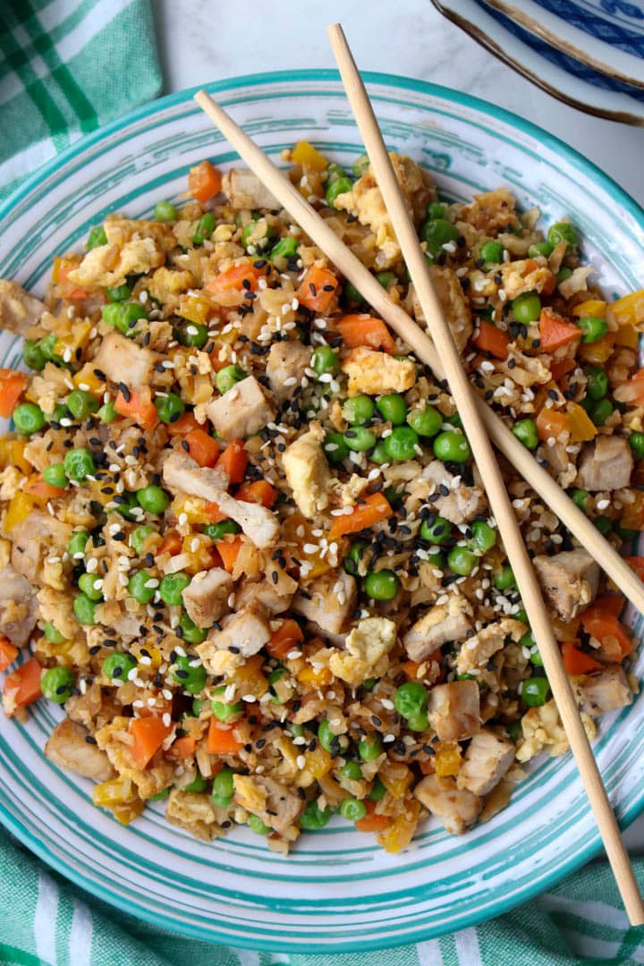 bowl of cauliflower pork fried rice with chop sticks