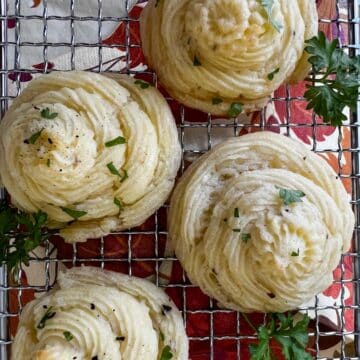 four duchess potatoes on a cooling rack