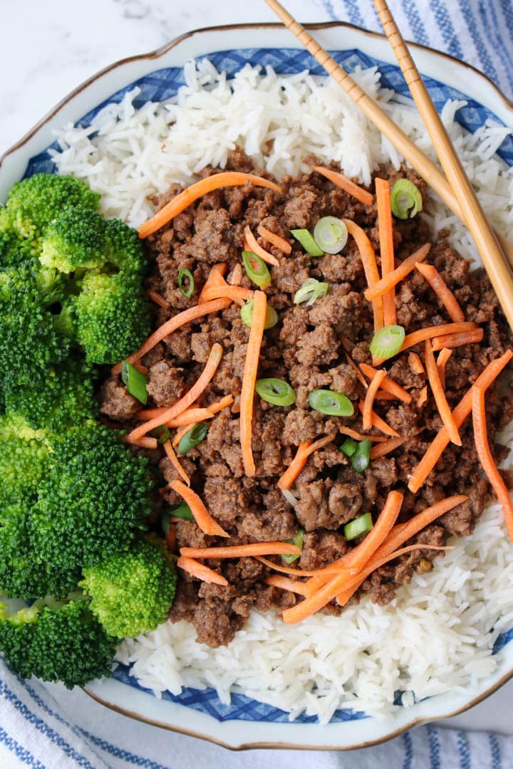 bowl of Korean beef on white rice with a side of broccoli