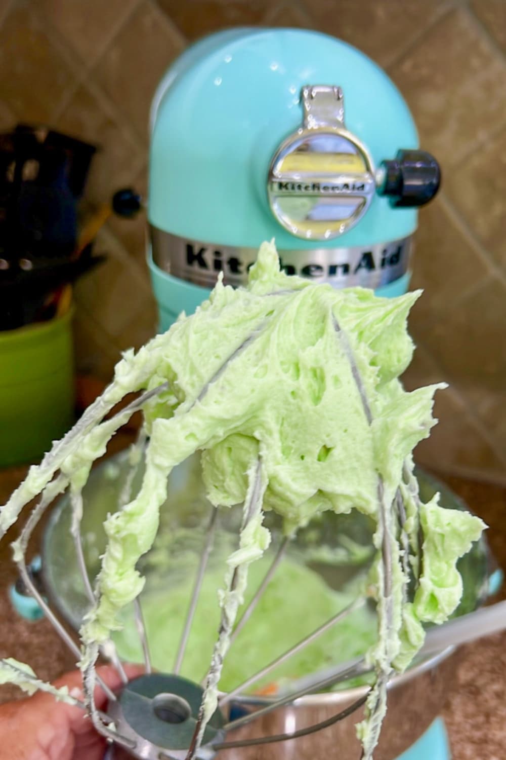 mixer whisk with pistachio pudding on it