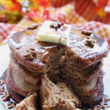 stack of gingerbread pancakes with a fork full cut out