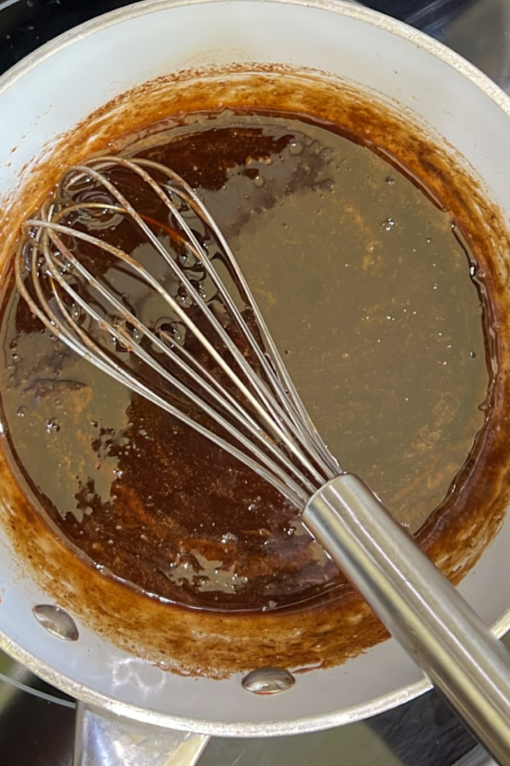 GINGERBREAD SYRUP IN A PAN WITH A WHISK