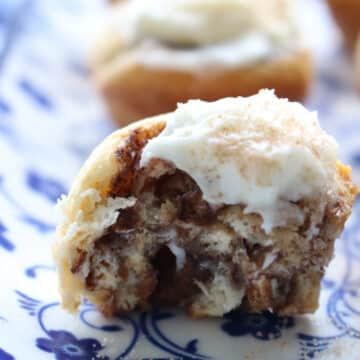 mini cinnamon roll with a bit taken out of it to expose the inside