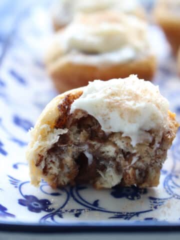 mini cinnamon roll with a bit taken out of it to expose the inside