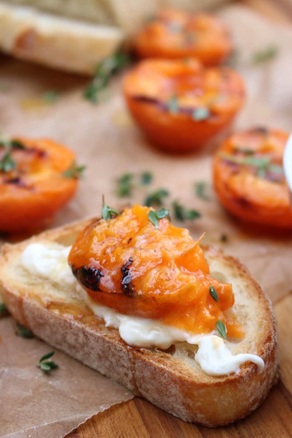 SLICE OF BAGUETTE TOPPED WITH BURRATA AND GRILLED APRICOT