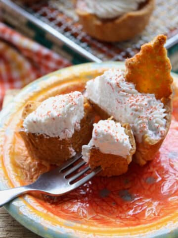 Mini Honey Pumpkin Pie on a plate with a bite on a fork