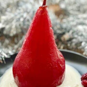 red wine poached pear on a bed of whipped ricotts