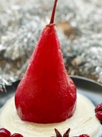 red wine poached pear on a bed of whipped ricotts