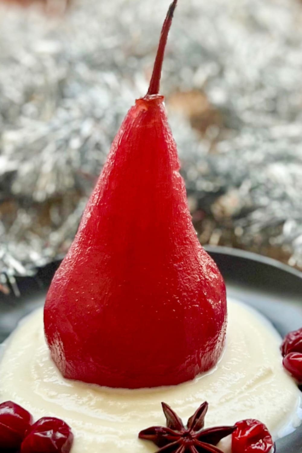 red wine poached pear on a bed of whipped ricotts