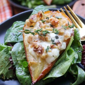 ROASTED PEAR STUFFED WITH BLUE CHEESE ON A BED OF GREENS