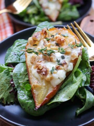 ROASTED PEAR STUFFED WITH BLUE CHEESE ON A BED OF GREENS