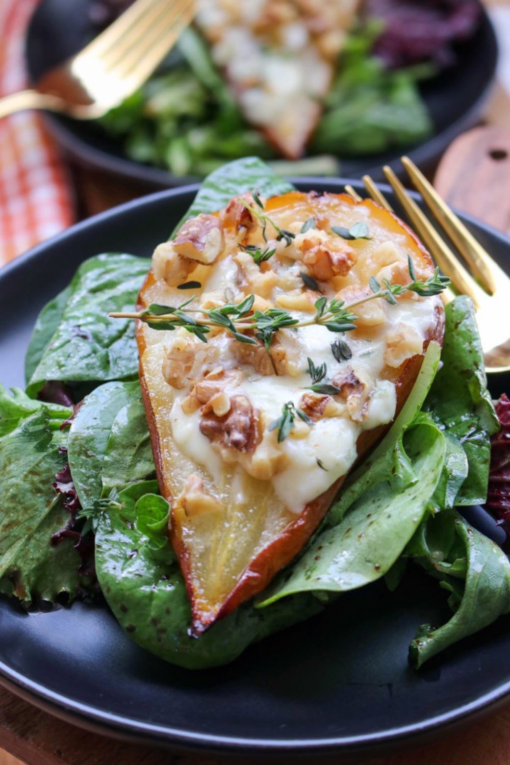 ROASTED PEAR STUFFED WITH BLUE CHEESE ON A BED OF GREENS