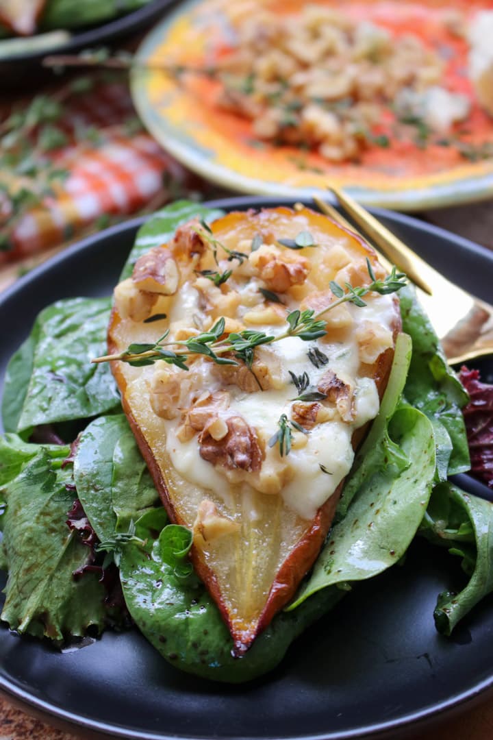 ROASTED PEAR STUFFED WITH BLUE CHEESE ON A BED OF GREENS