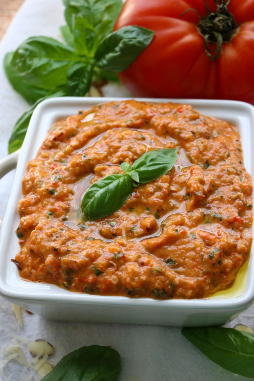 square bowl filled with roasted tomato garlic pesto