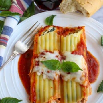 TWO CANNELLONI ON A WHITE PLATE