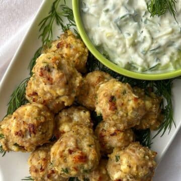 chicken feta meatballs with a bowl of taztiki sauce