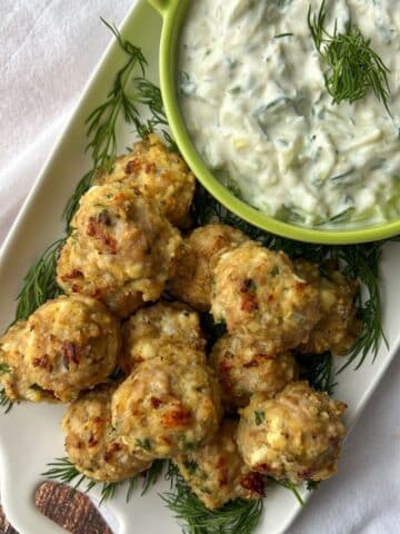 chicken feta meatballs with a bowl of taztiki sauce