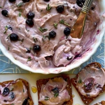 Overhead shot of berry goat cheese bowl and crackers