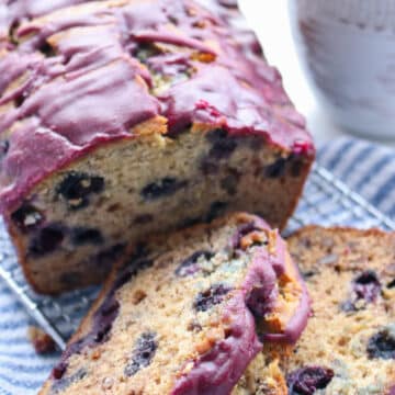 loaf of blueberry banana bread with first two slices