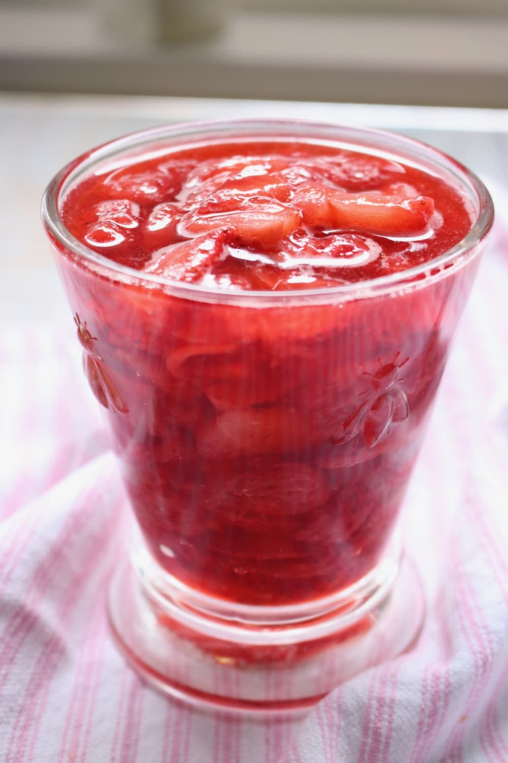 glass jar of strawberry sauce