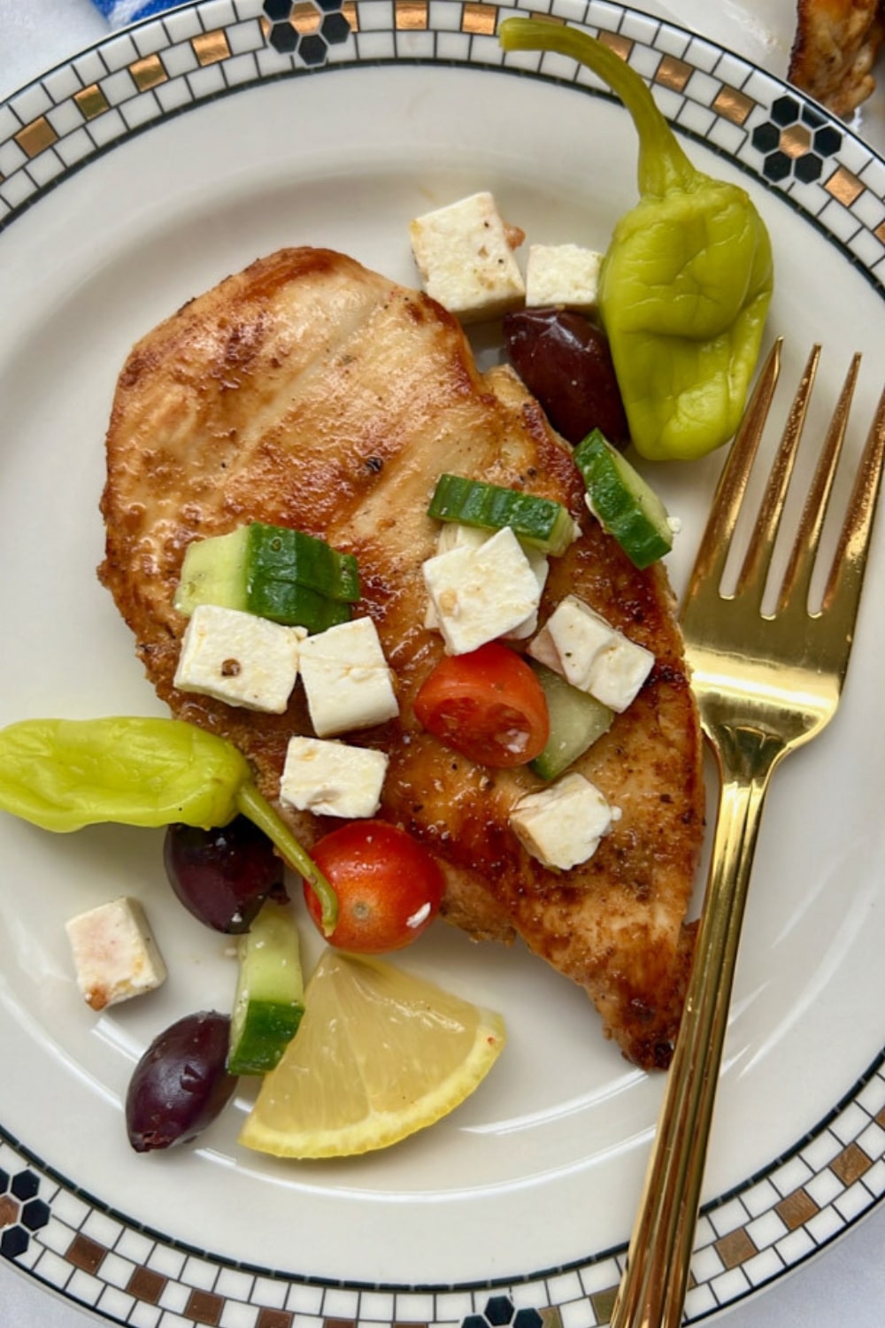 CHICKEN BREAST ON A PLATE TOPPED WITH FETA SALAD