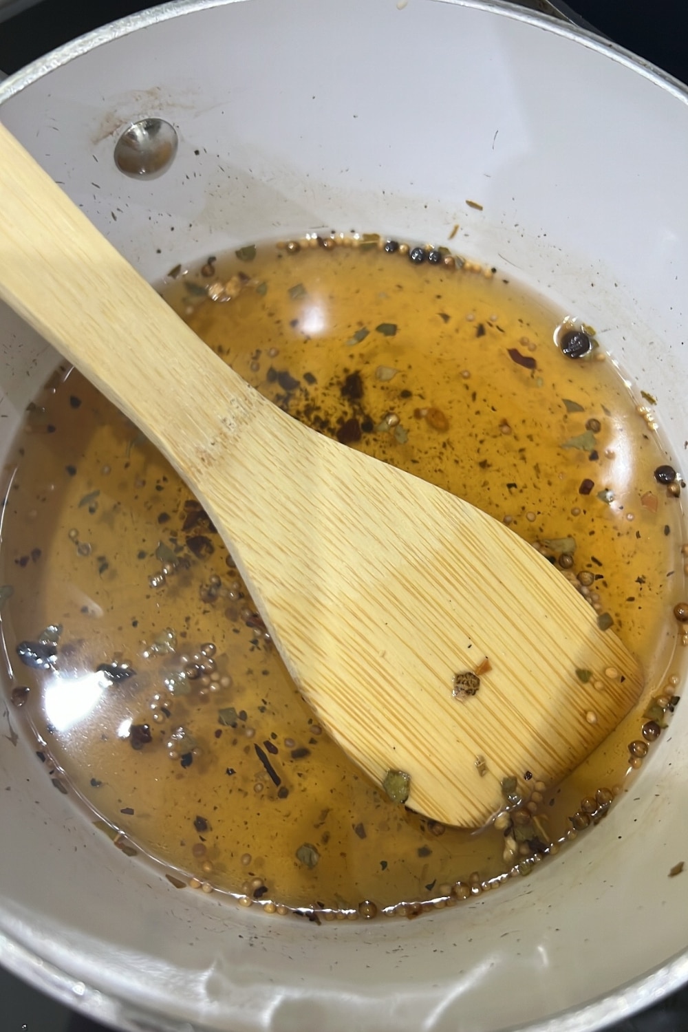 white pan with vinegar and pickling spices