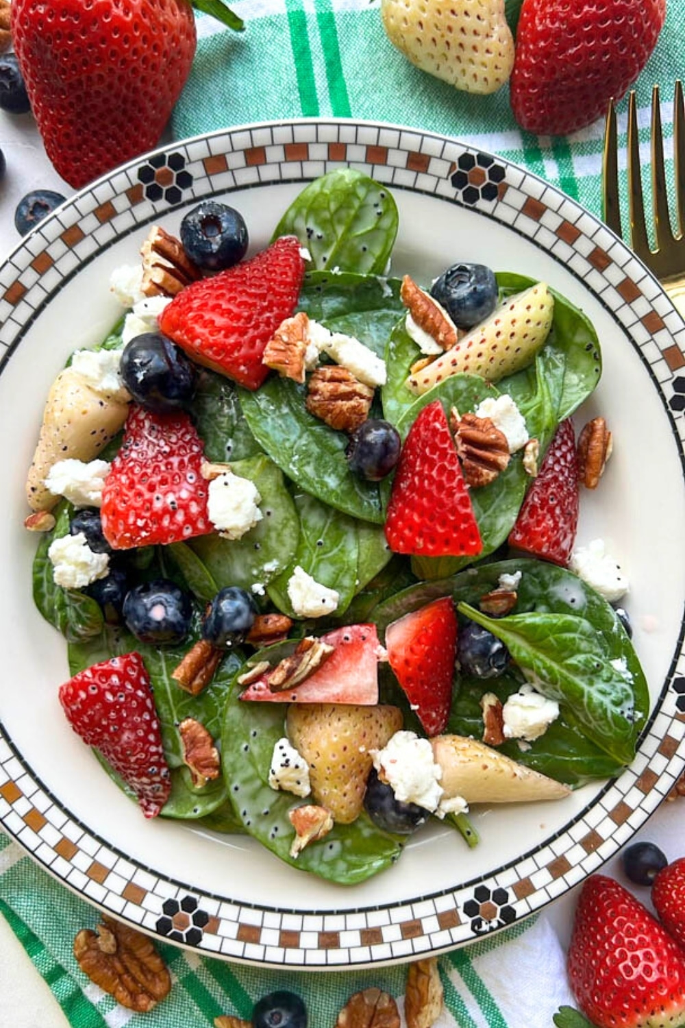 bowl of red white blue spinach berry salad