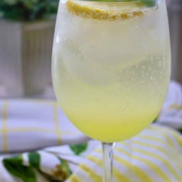 Glass of limoncello spritz with mint garnish