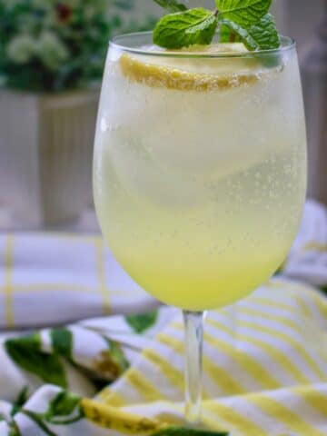 Glass of limoncello spritz with mint garnish