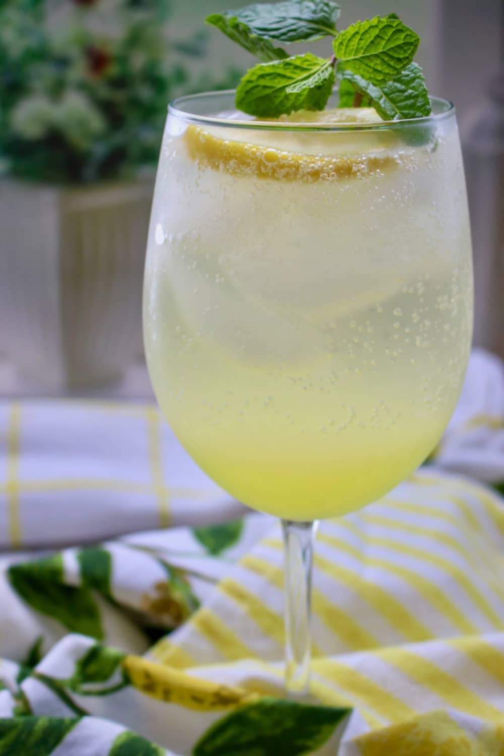 Glass of limoncello spritz with mint garnish