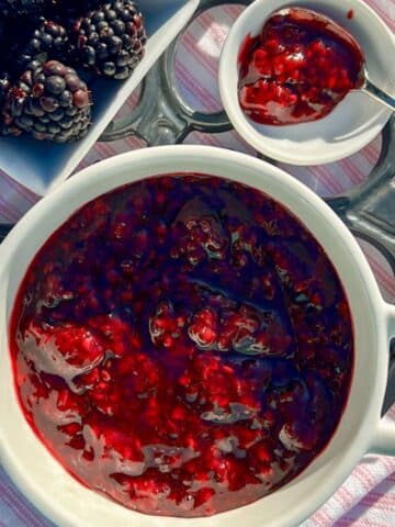 BLACKBERRY JAM IN A BOWL WITH A SIDE OF FRESH BERRIES