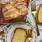 Orange loaf cake with two slices on a plate.