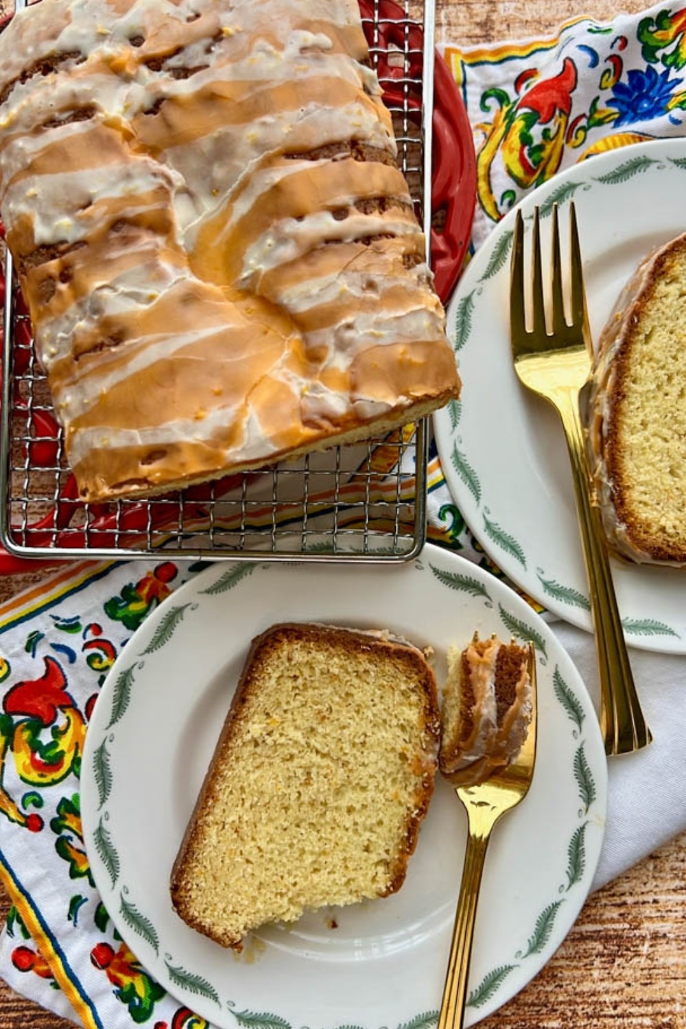 Orange loaf cake with two slices on a plate.
