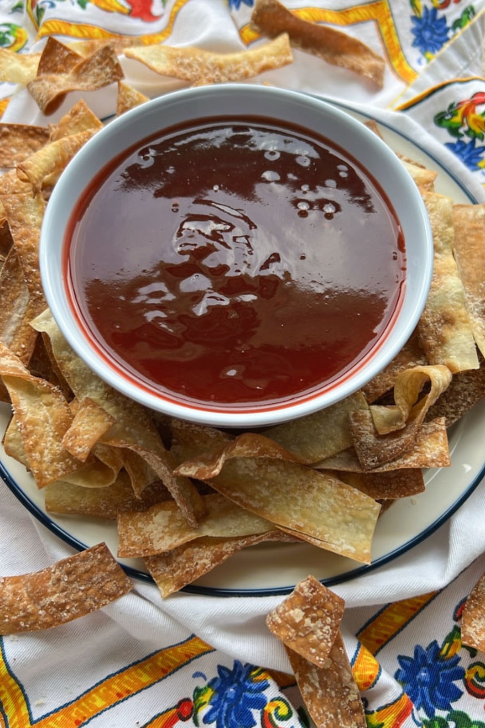 bowl of sweet and sour sauce with wonton chips