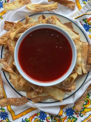 bowl of sweet and sour sauce with wonton chips