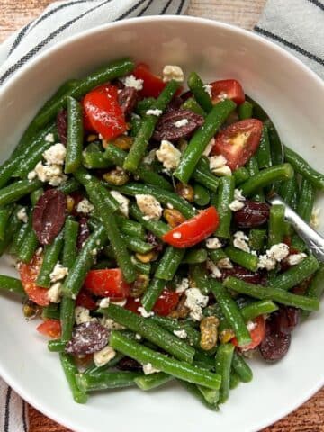 GREEK GREEN BEAN SALAD IN A WHITE BOWL