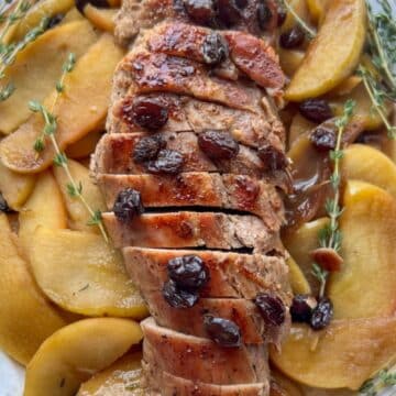 ROASTED PORK TENDERLOIN WITH APPLES ON A SERVING PLATTER