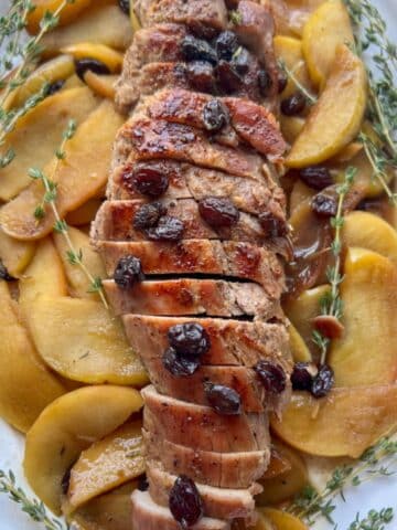 ROASTED PORK TENDERLOIN WITH APPLES ON A SERVING PLATTER