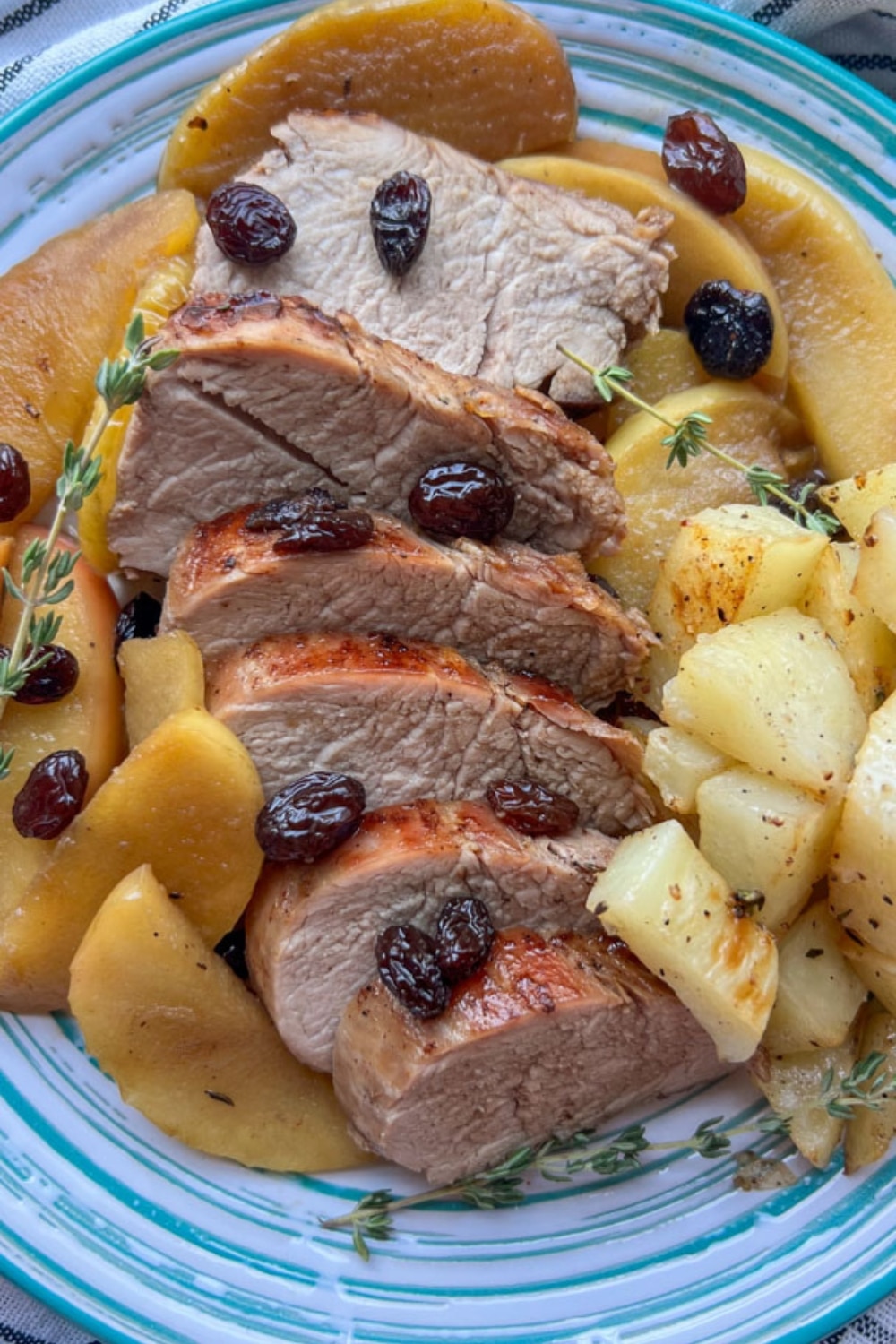 PLATE OF ROASTED PORK TENDERLOIN SLICES AND APPLES