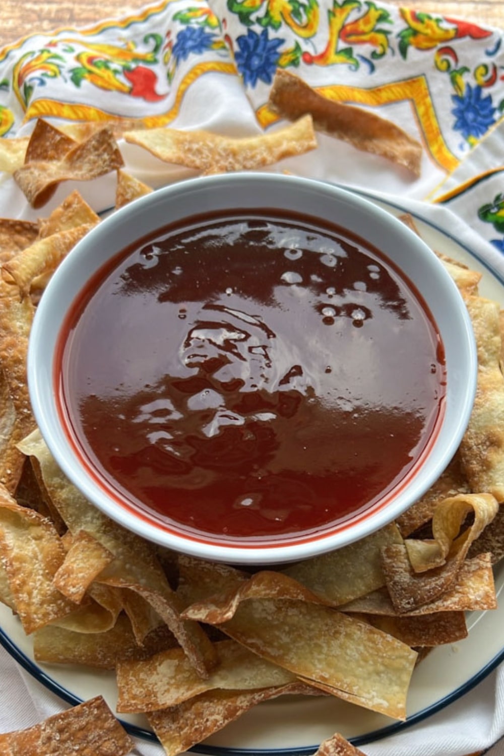 bowl of sweet and sour sauce with wonton chips