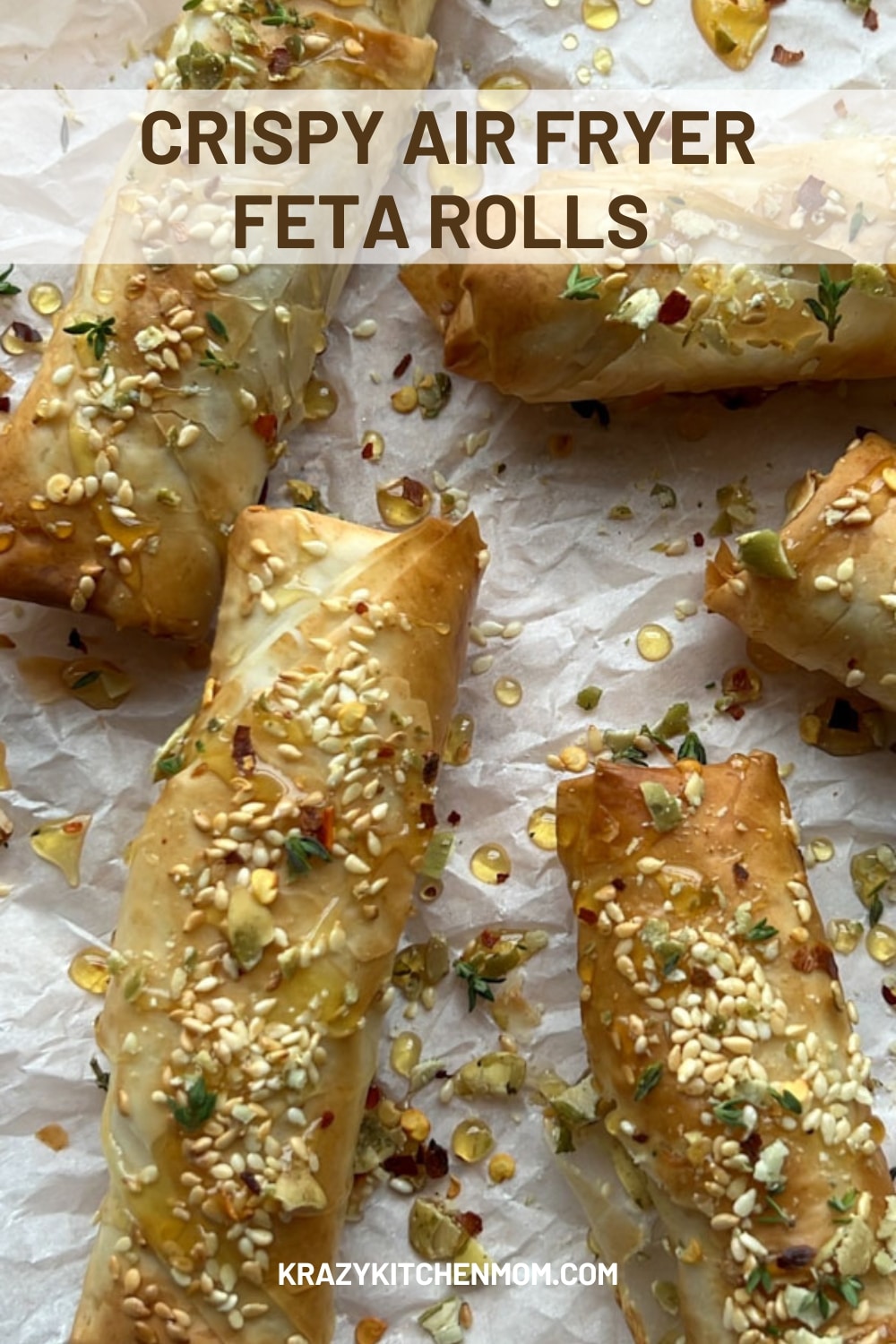 Crispy Air Fryer Feta Rolls are a delightful blend of crispy, golden pastry wrapped around creamy, tangy feta cheese, topped with honey creating an irresistible and stunning appetizer. via @krazykitchenmom